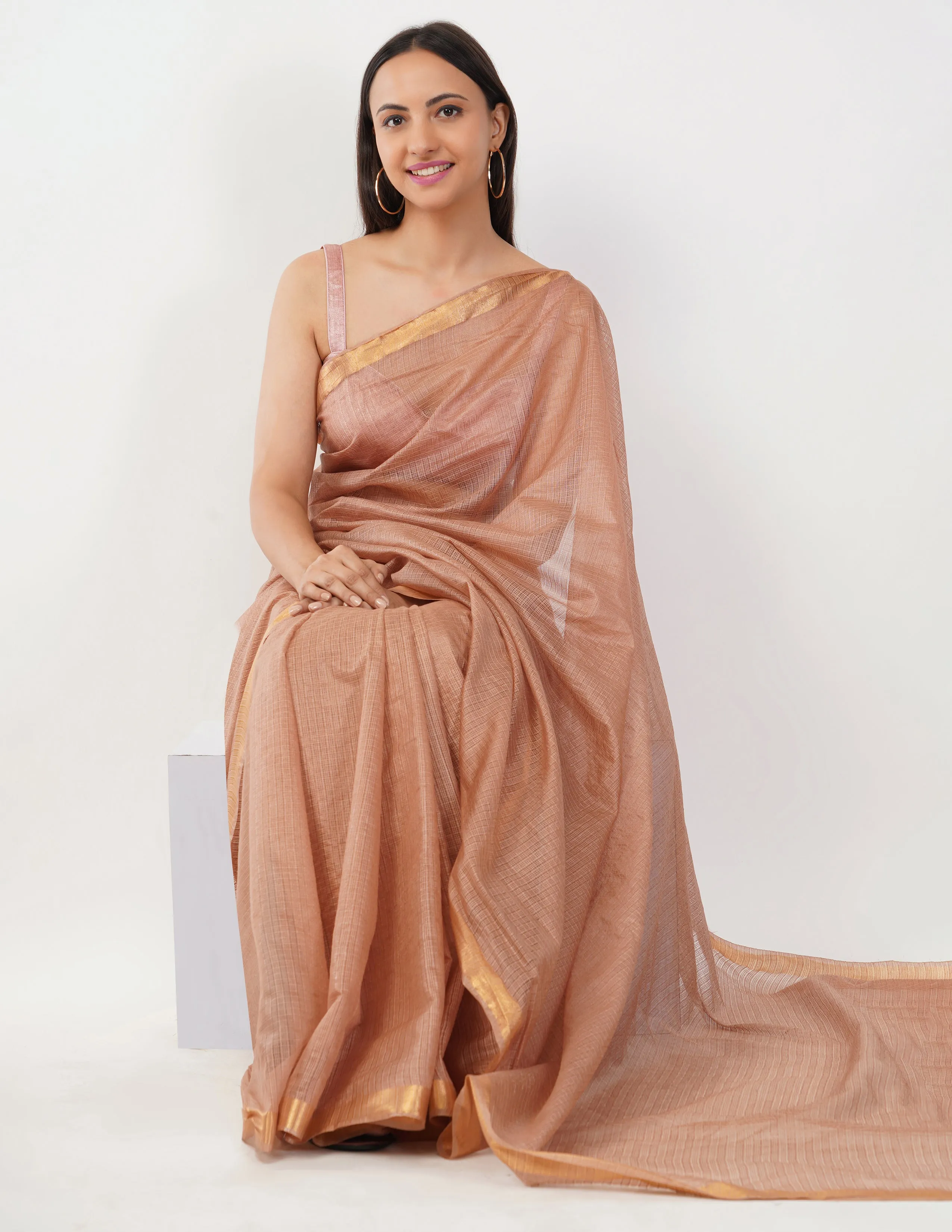 Blush-toned body with a subtle golden shimmer  Saree