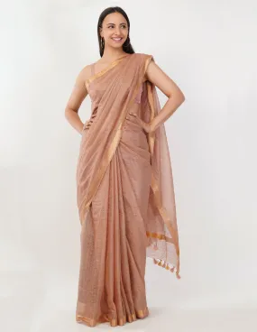 Blush-toned body with a subtle golden shimmer  Saree